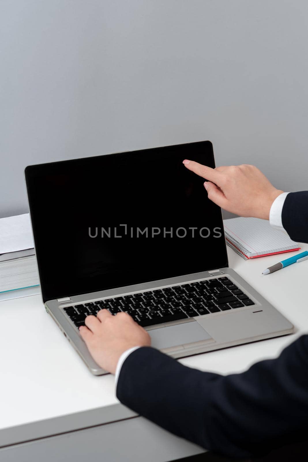 Woman Typing Updates On Lap Top And Pointing New Ideas With One Finger.