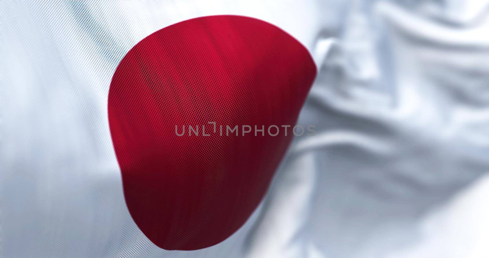 Close-up view of the Japanese national flag waving in the wind. Japan is an Asian country. Fabric background