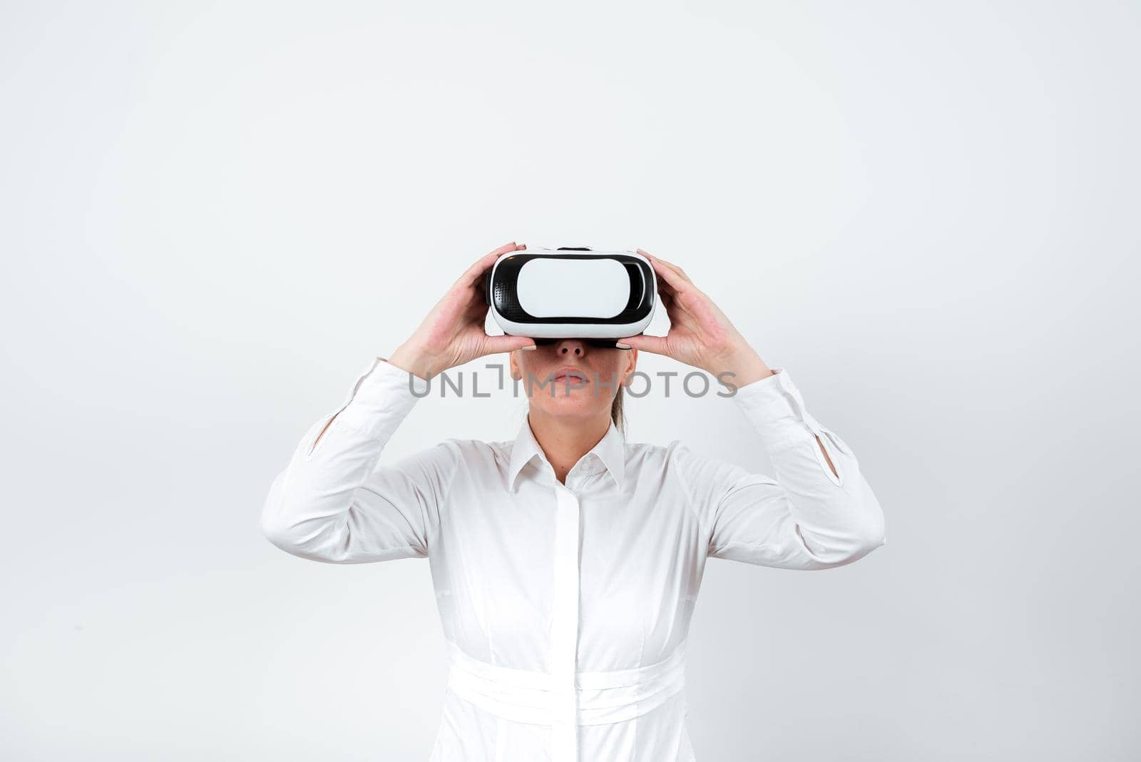 Standing Man Wearing Vr Glasses Presenting Important Messages. Businessman Having Virtual Reality Eyeglasses And Showing Crutial Informations. Female Seeing New Ideas. by nialowwa
