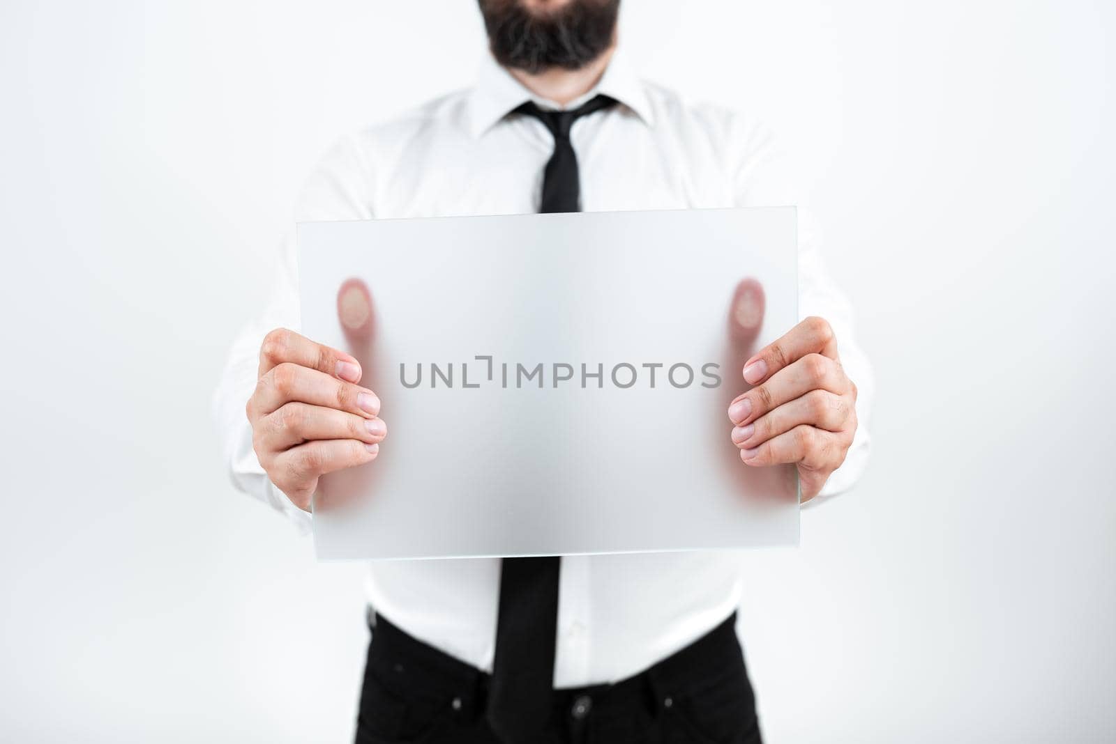 Businessman With Placard Presenting Important Strategies For Progress.