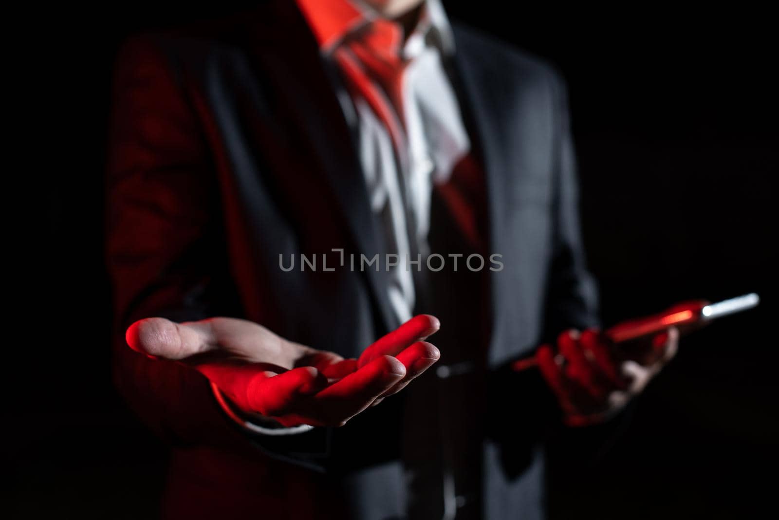 Businessman Holding Important Message In One Hand. Man In Suit Showing New Crutial Idea In A Palm. Executive Presenting Updated Critical Information. by nialowwa