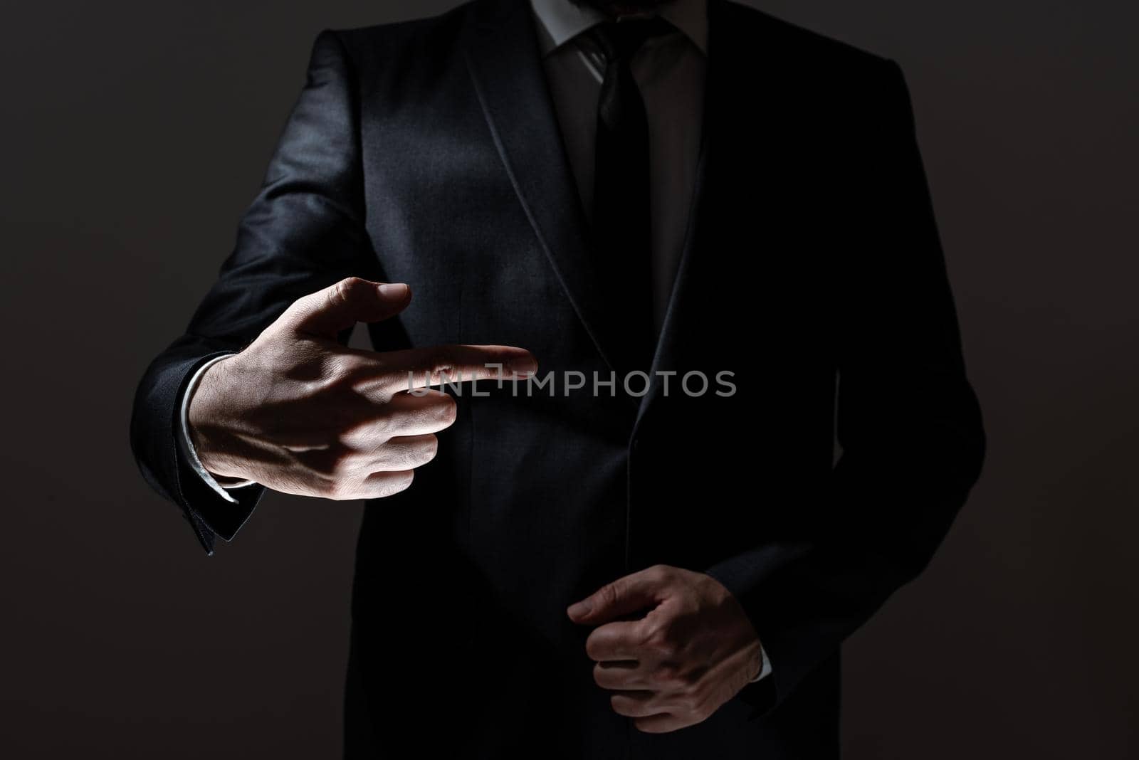 Businessman Pointing With One Finger On Important Messages. Executive In Suit Presenting Crutial Informations. Gentleman Showing Critical Announcement. by nialowwa