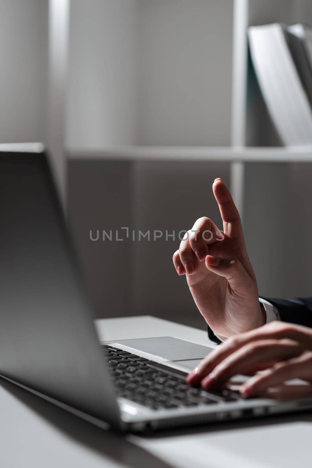 Woman Typing Updates On Lap Top And Pointing New Ideas With One Finger.