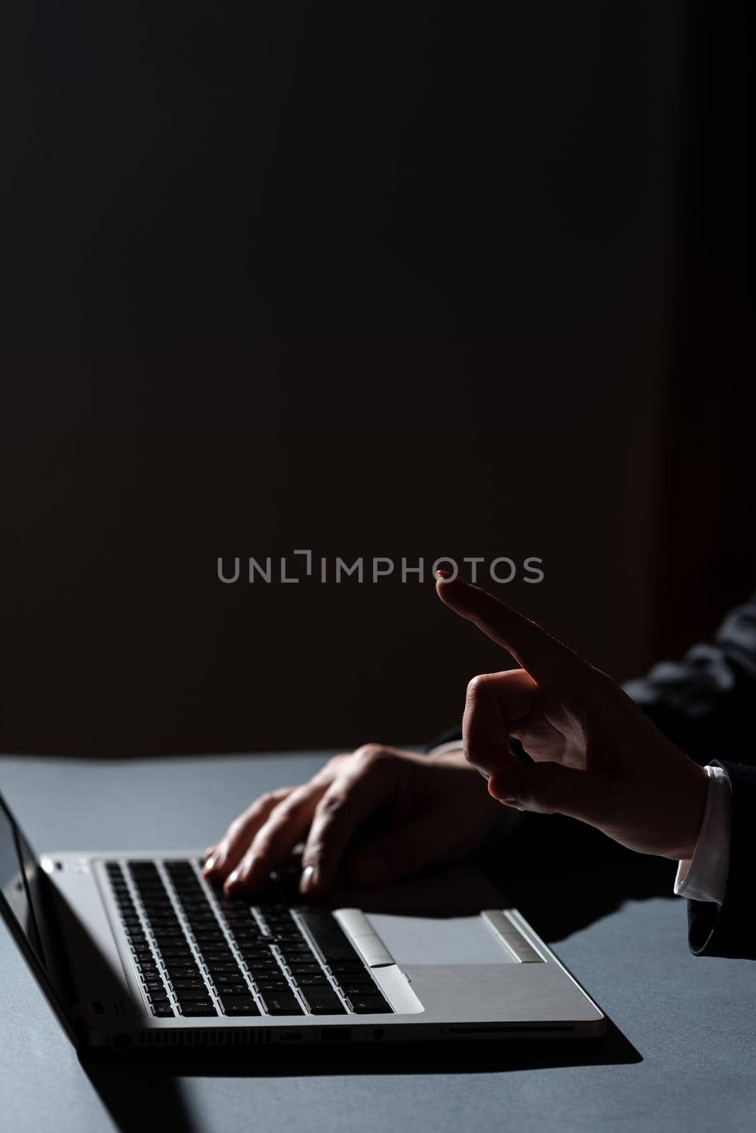 Man Typing On Lap Top And Woman Pointing With One Finger On Important Message. Businessman Writing On Computer And Businesswoman Presenting Crutial Informations. by nialowwa