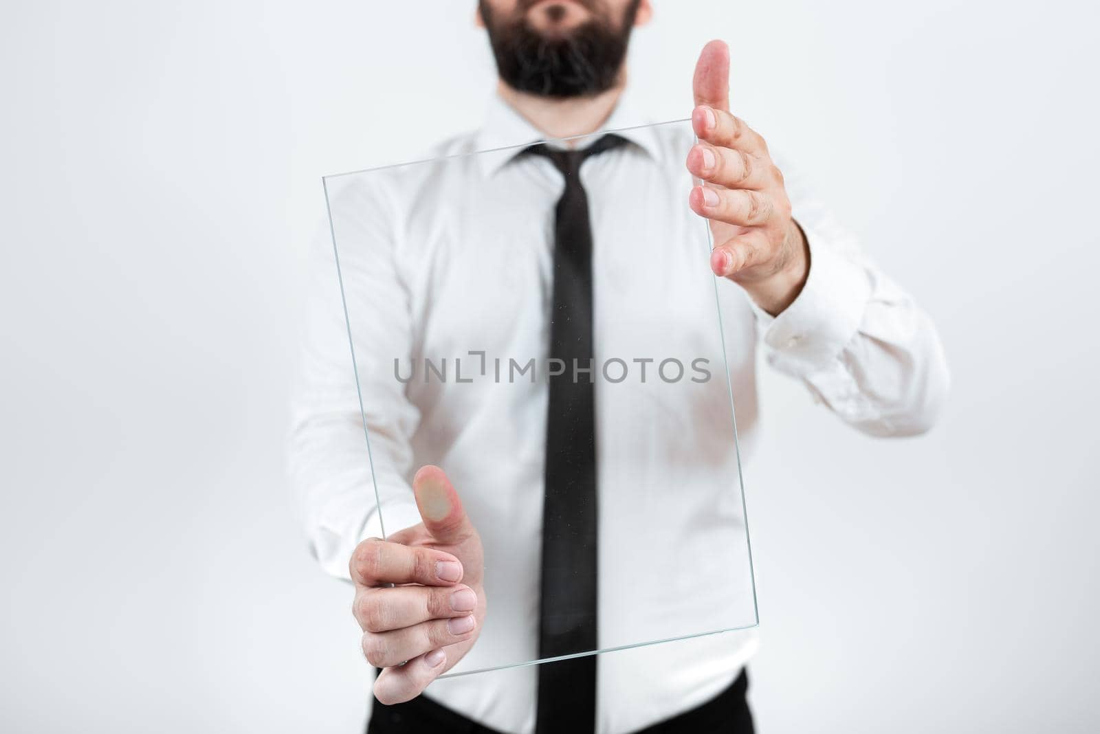 Male Corporate Holding Transparent Glass And Presenting Important Sales Data. Businessman Wearing Necktie Displaying New Ideas And Strategies For The Marketing. by nialowwa