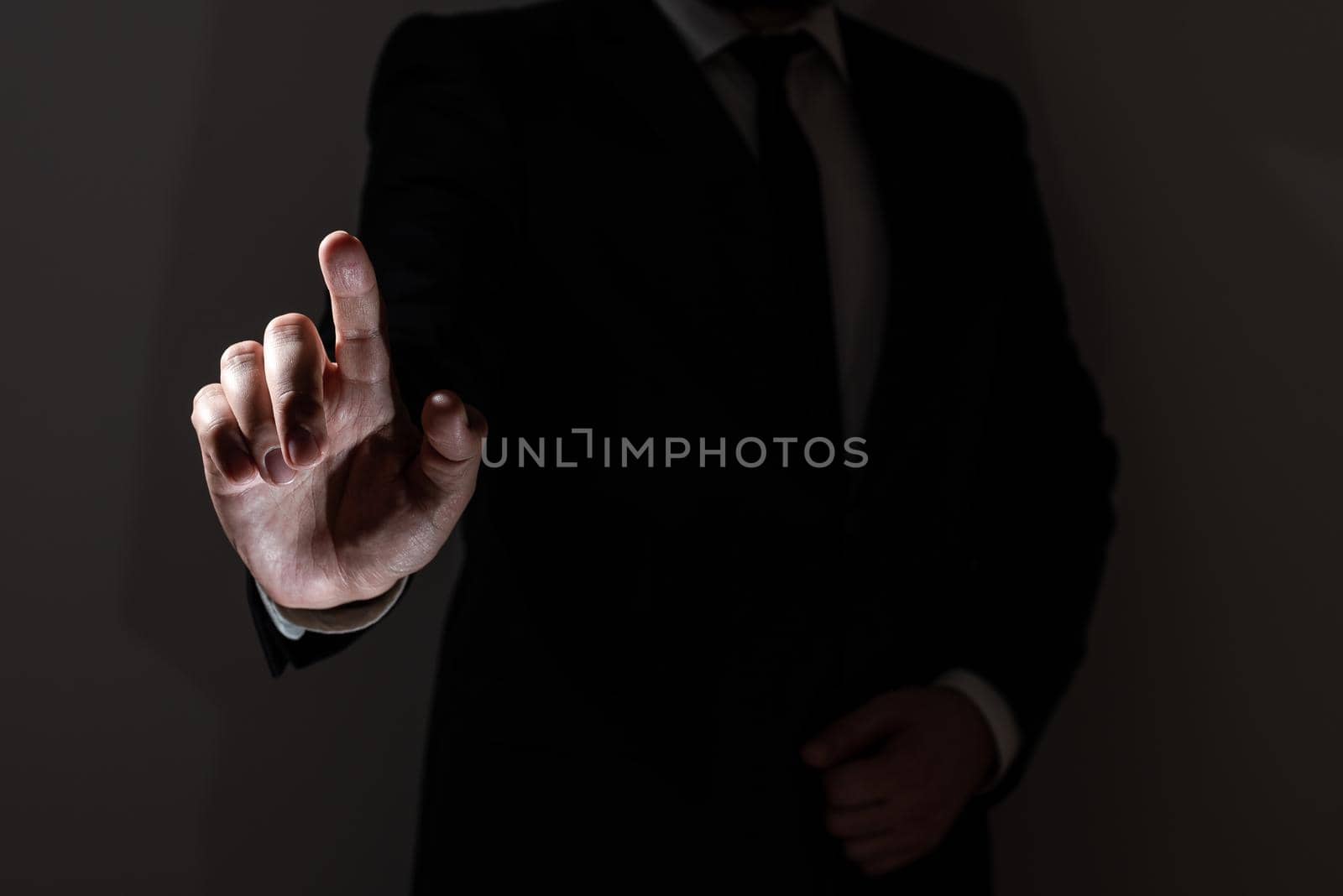 Businessman Pointing With One Finger On Important Messages. Executive In Suit Presenting Crutial Informations. Gentleman Showing Critical Announcement. by nialowwa