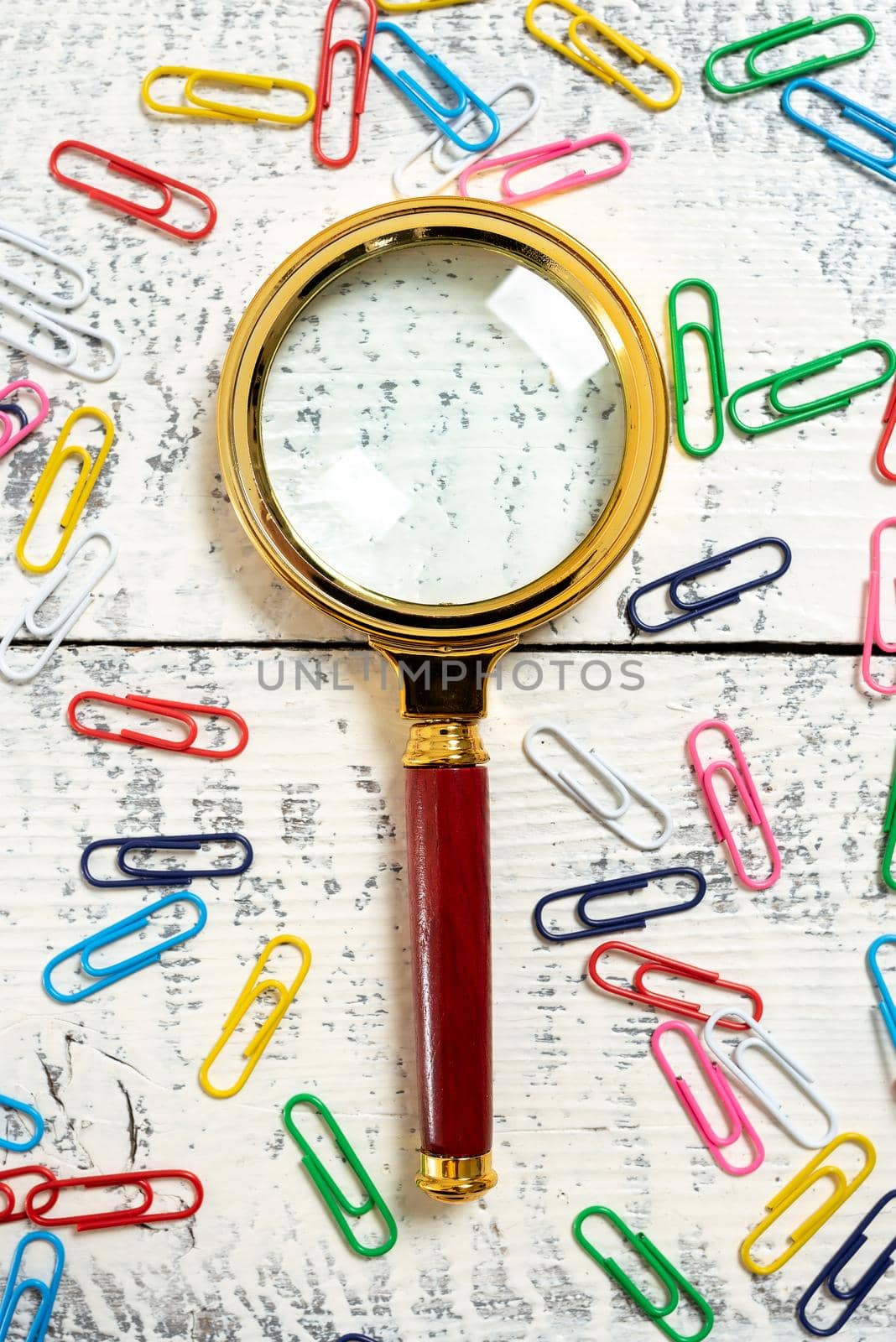 Magnifier With Important Message With Paperclips Around On Floor. Magnifying Glass With Crutial Data With Clips All Over. Optical Instrument Showing New Ideas. by nialowwa