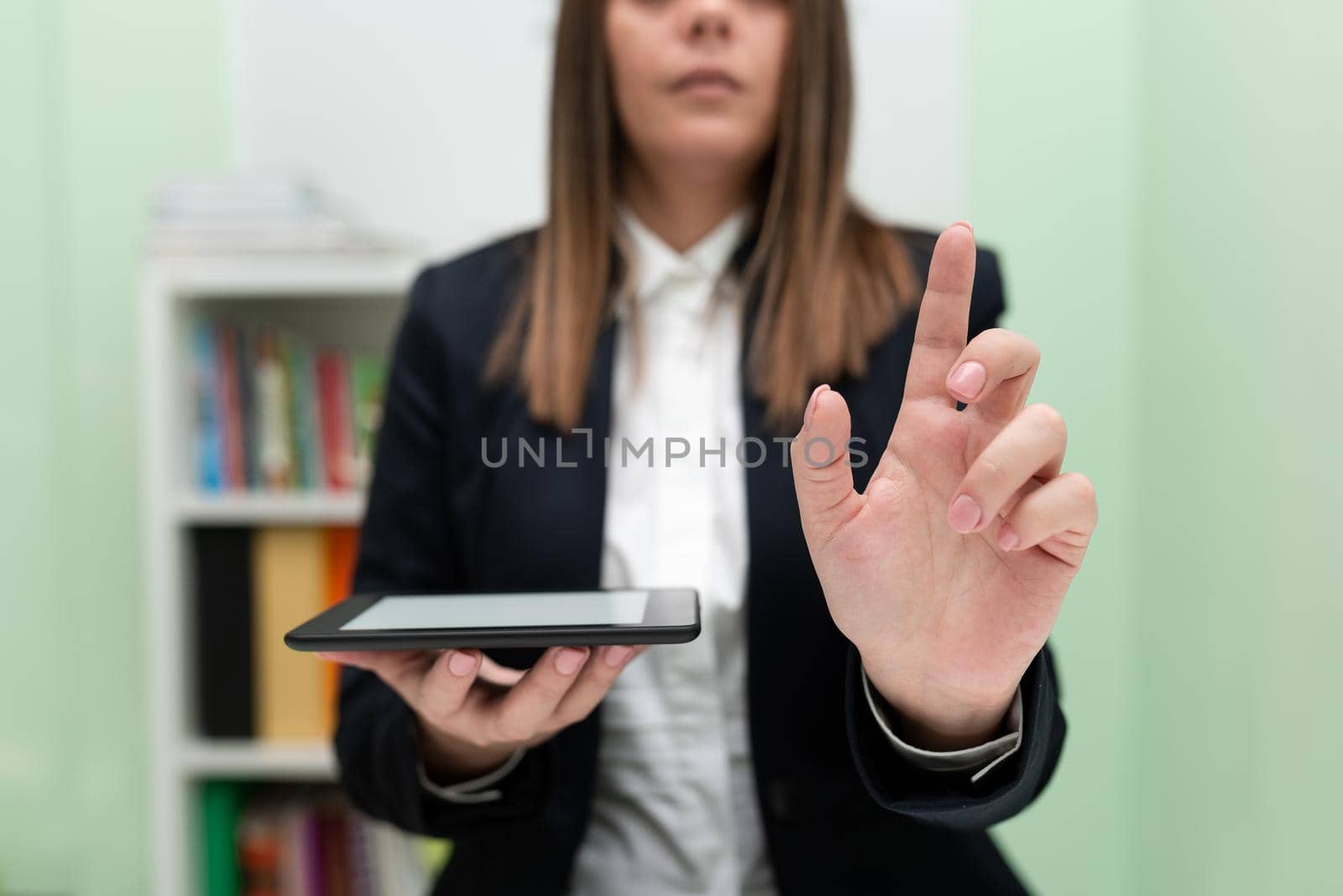 Businesswoman Holding Cellphone And Pointing Important Ideas With One Finger. Woman Having Phone And Showing Recent Updates On Screen. Executive Displaying Late News. by nialowwa