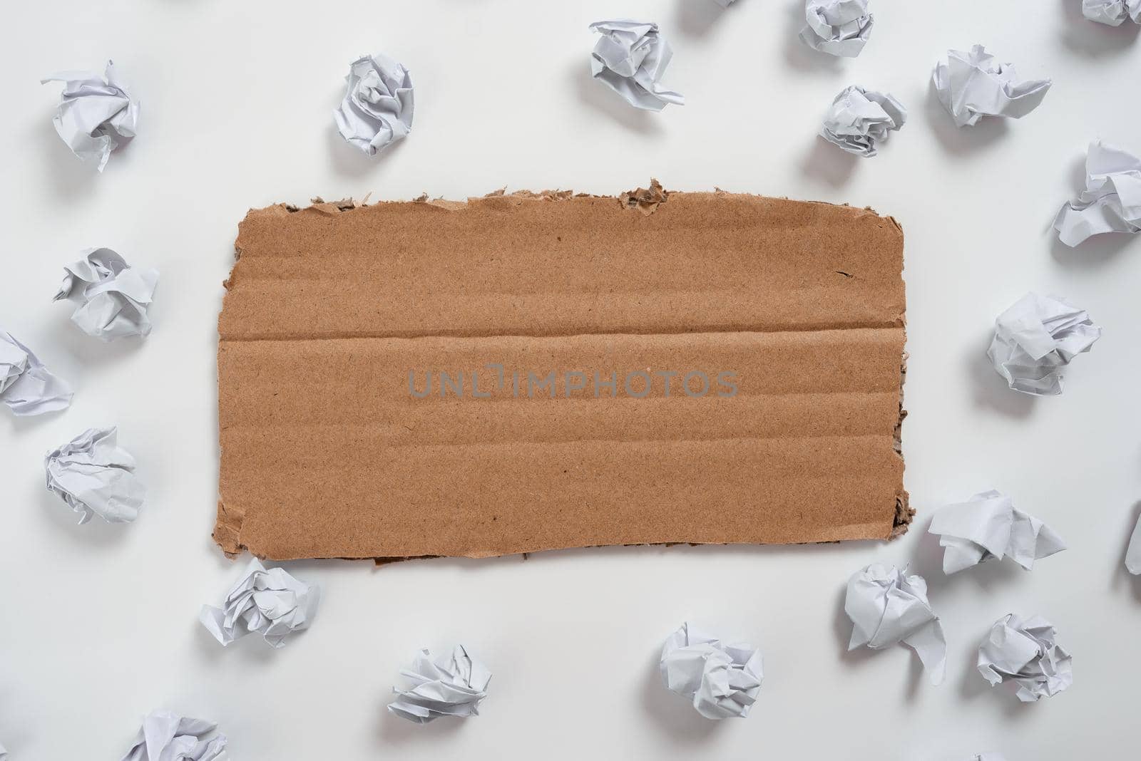 Piece Of Carboard With Important Message Surrounded By Paper Wraps.