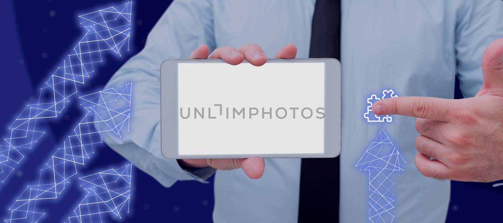 Businessman Holding A Touch Screen And Pointing On A Jigsaw With Abstract Arrows Design. Man In A Necktie Working On Computer Applications And Digital Information. by nialowwa