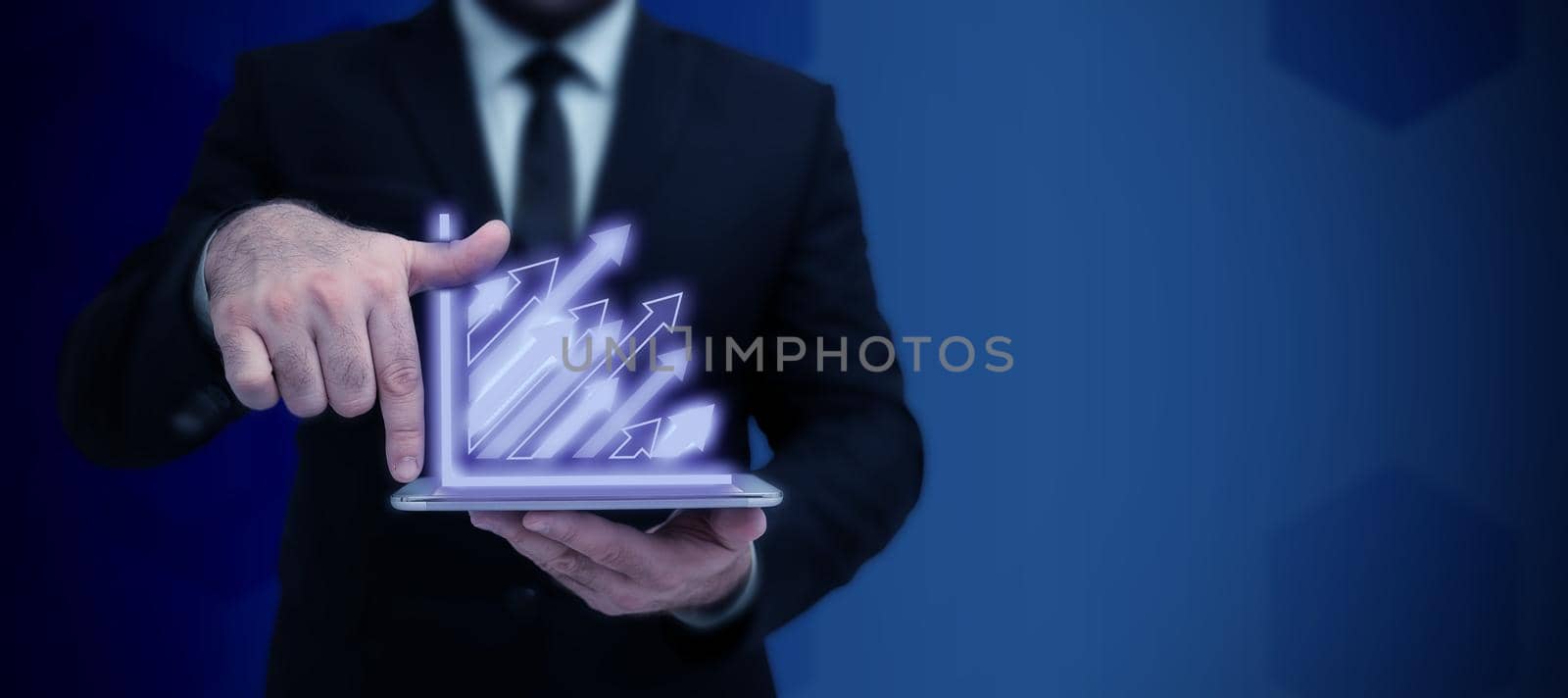 Businessman in suit holding tablet symbolizing successful teamwork.