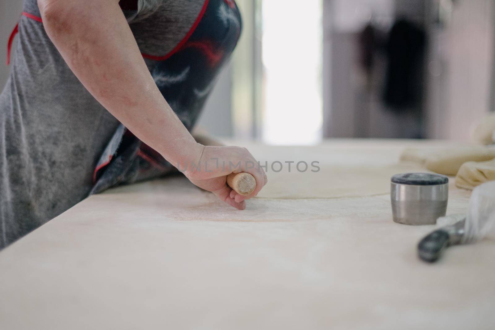 Front view of woman's hands making meat dumpling. The process of making homemade dumplings. Minced meat on dough, the process of cooking italian ravioli. Russian food.