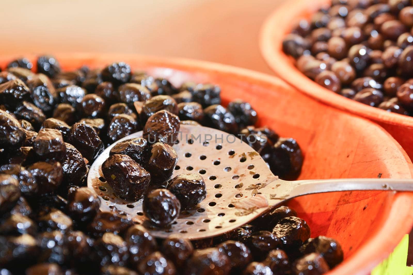 Closeup of black olives in a bowl on the market