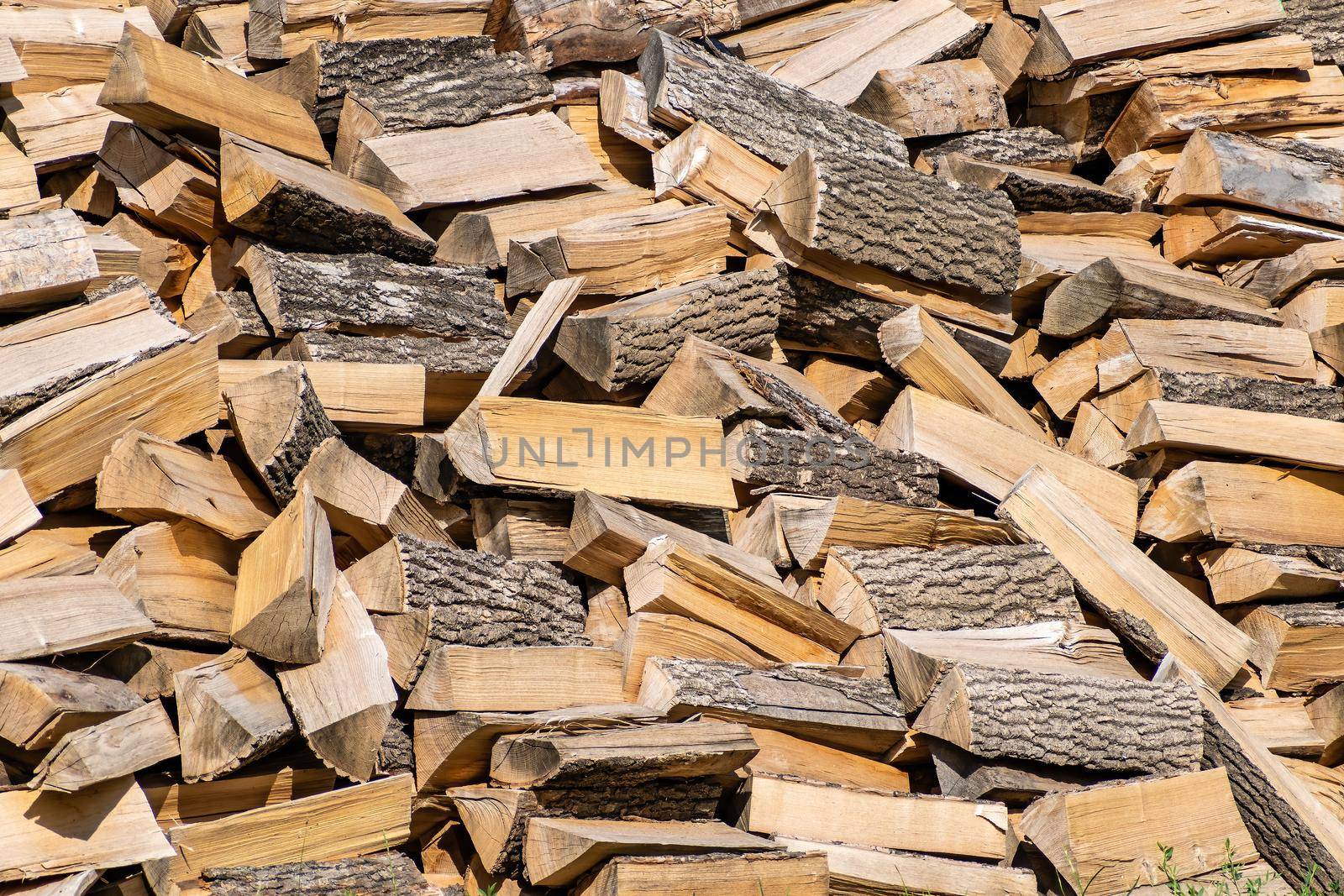 Texture, background for further work. A large pile of chopped firewood for the winter