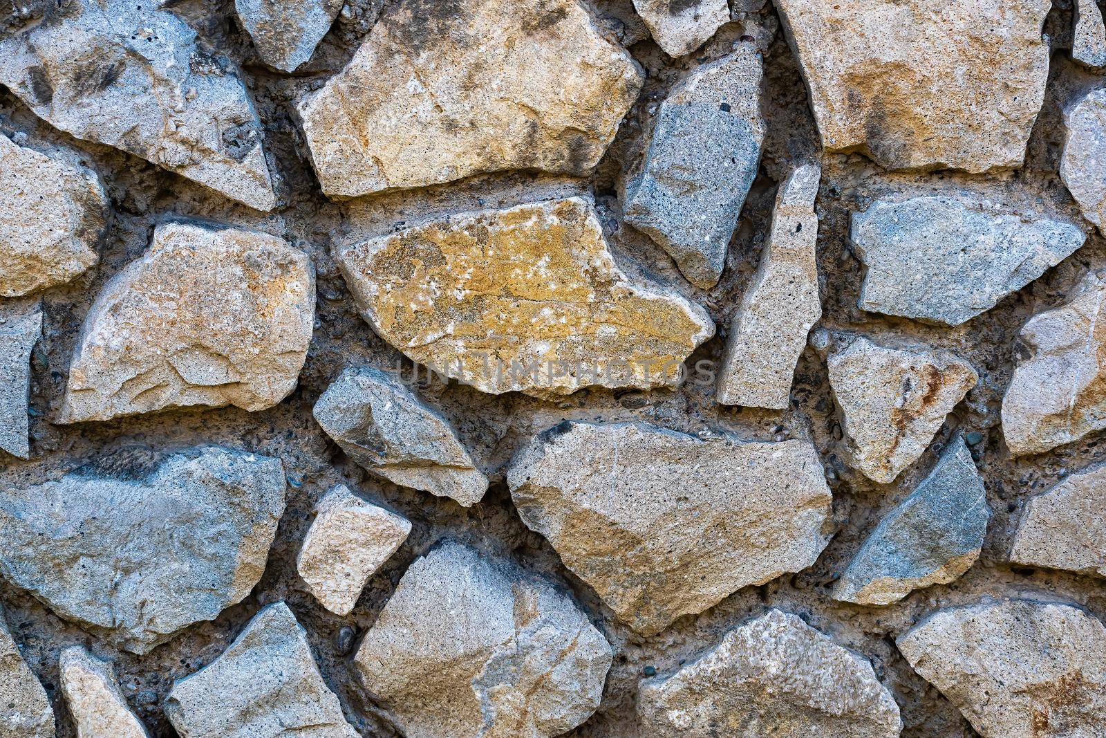 Texture, background for further work. A wall of coarse stone with a wide gap