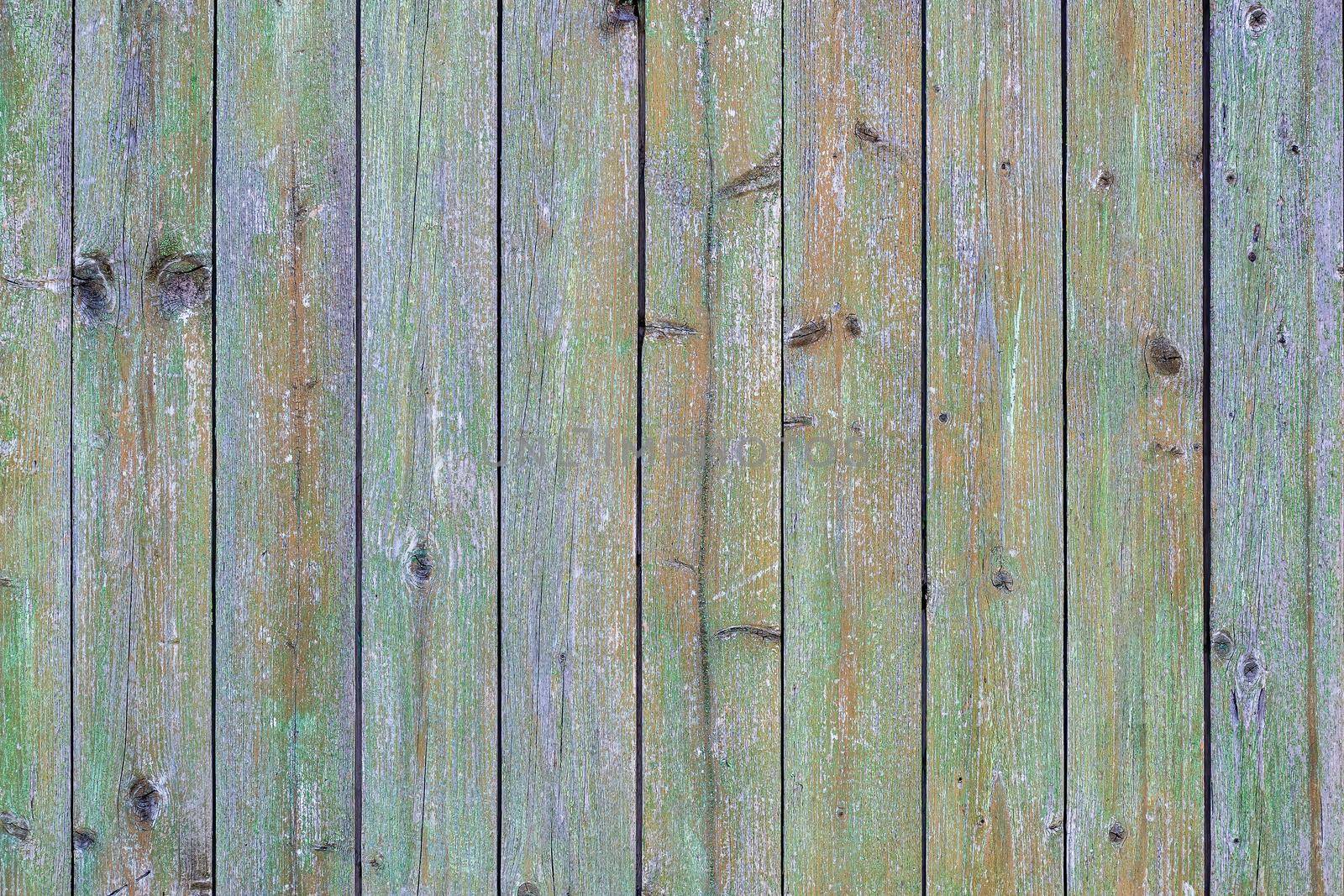 Texture, background for further work. Wall of vertically folded planks with paint residues