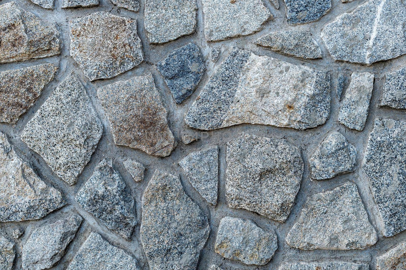 An area composed of large, gray irregular stones Texture, background for further work.