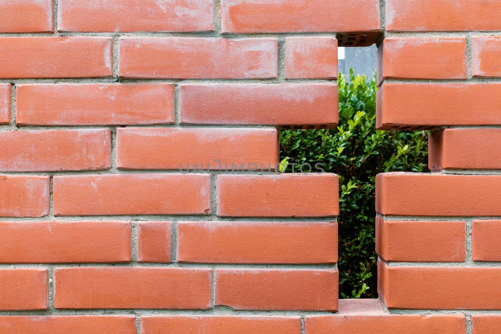 Brick wall with a hole in the form of a cross Texture, background for further work.
