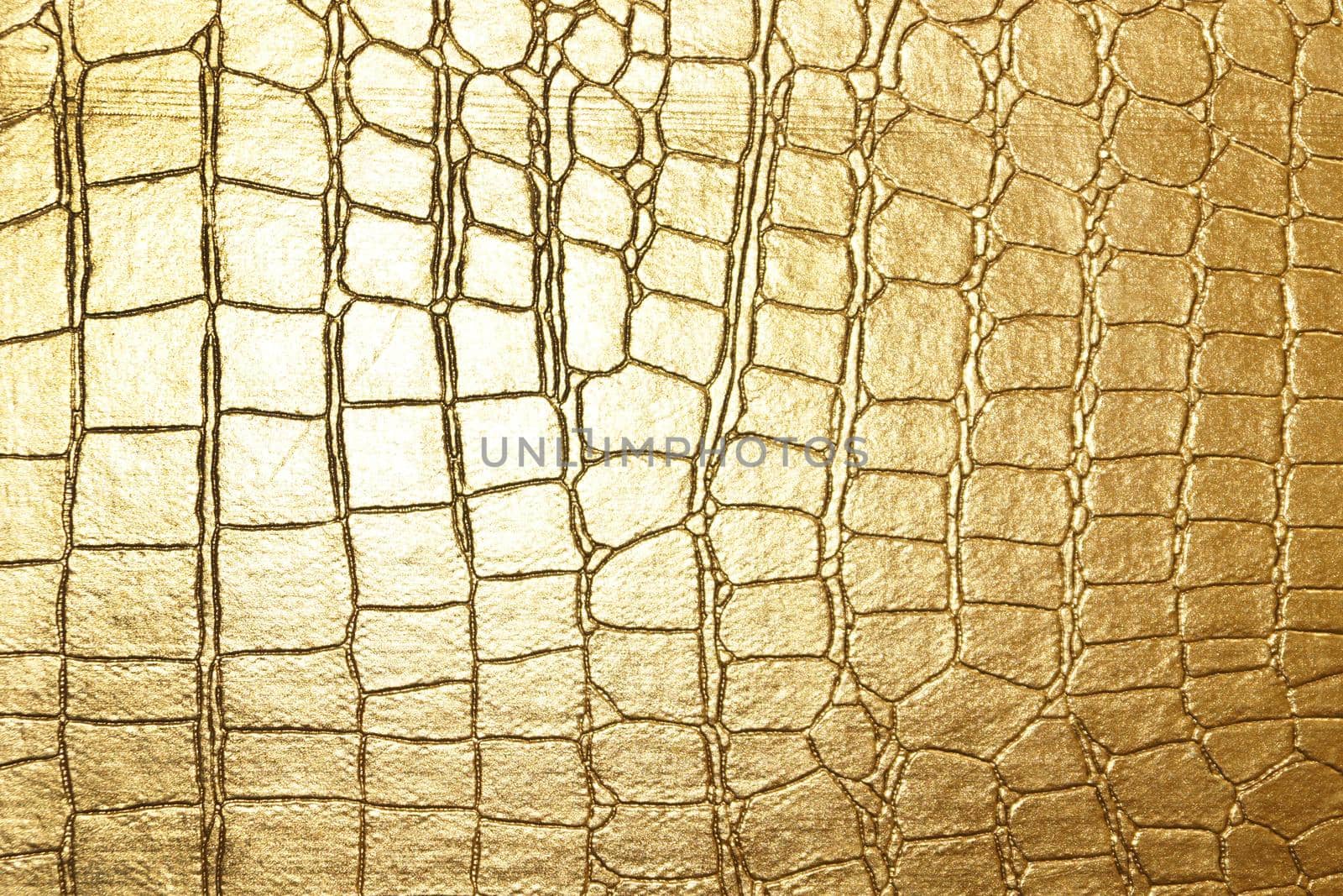 yellow gold crocodile skin texture close up.