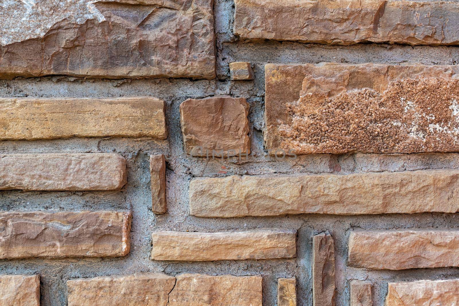 Wall composed of rectangular segments of stone Texture, background for further work.