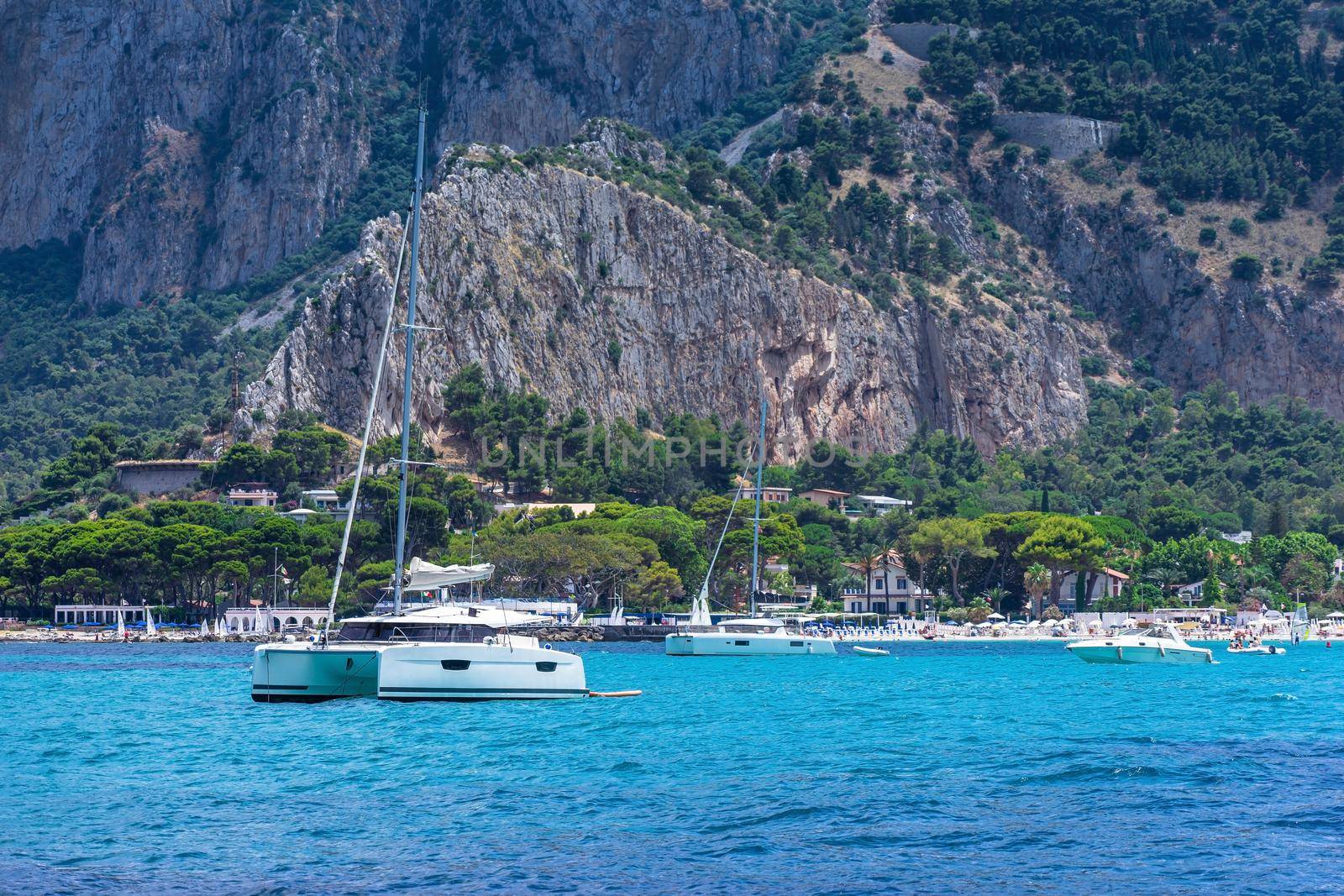 View from the sea of the bay and Mondello beach, catamaran anchored in the bay by smrcoun
