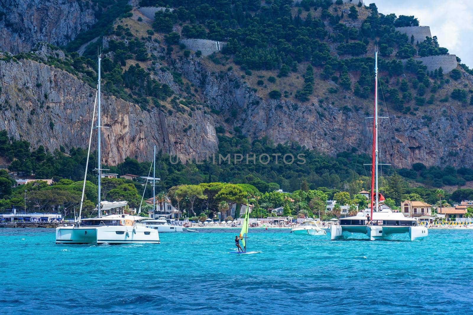 View from the sea of the bay and Mondello beach, catamarans anchored in the bay by smrcoun