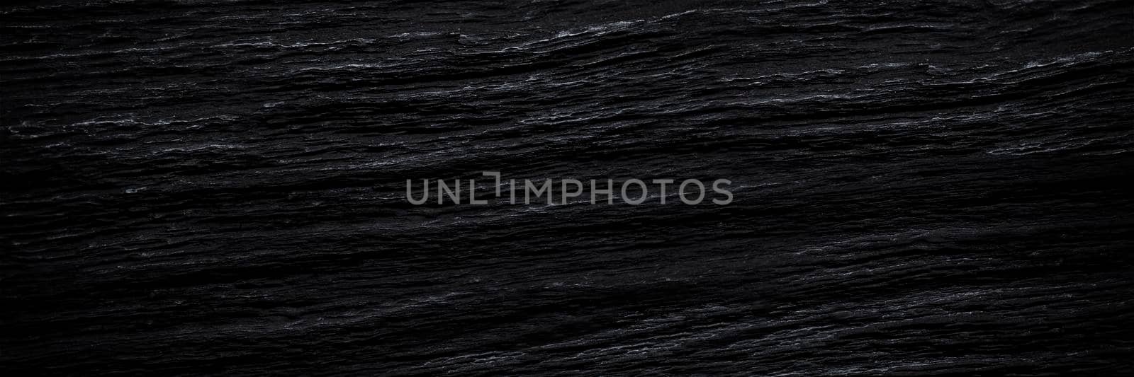 Texture of black old wood. Close-up of the texture of deep black bog oak. Sinuous wood texture with shadow. by SERSOL