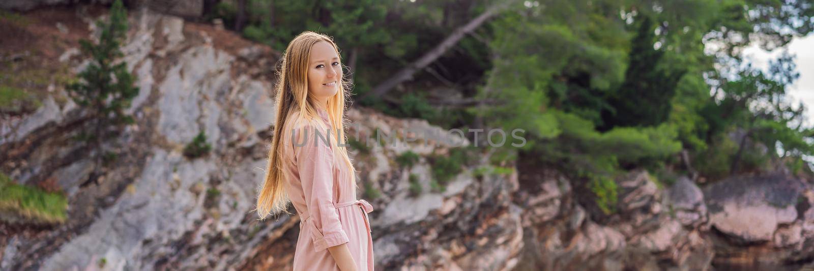 BANNER, LONG FORMAT Woman tourist walking together in Montenegro. Panoramic summer landscape of the beautiful green Royal park Milocer on the shore of the the Adriatic Sea, Montenegro by galitskaya