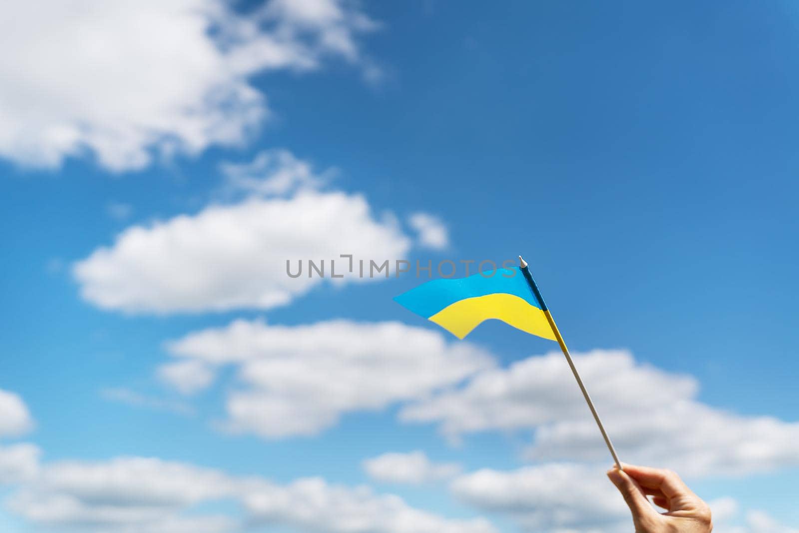 Pray for Ukraine. Ukrainian national yellow-blue flag against a beautiful sky. Independence Day 24 August