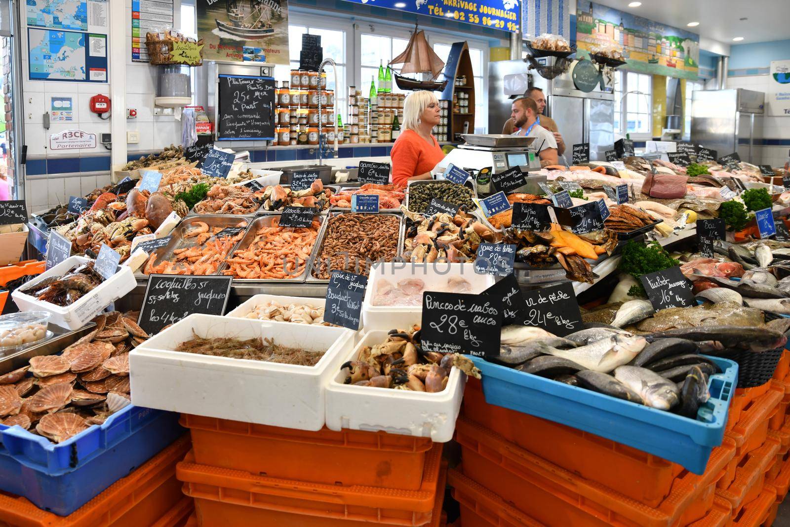 LE TREPORT, FRANCE - OCTOBER 13, 2018: A counter with fresh fish, shrimp, oysters, lobster, snails, scallop,shell at the local famous fish market