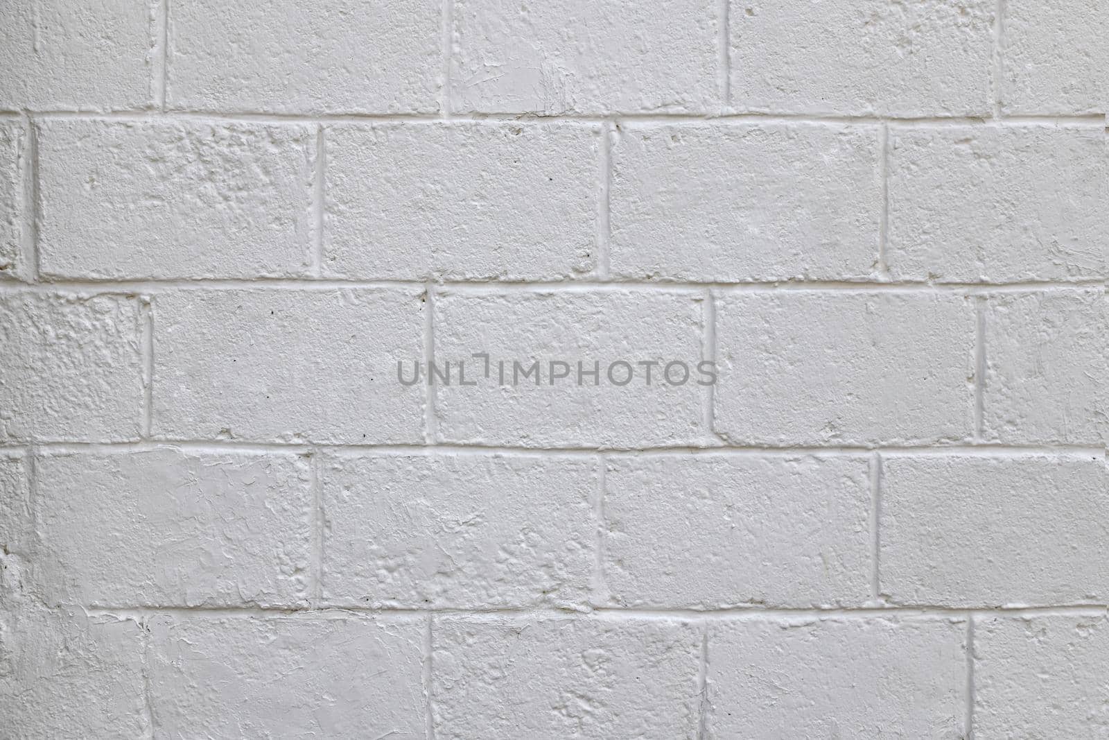The old white concrete tile wall background and texture