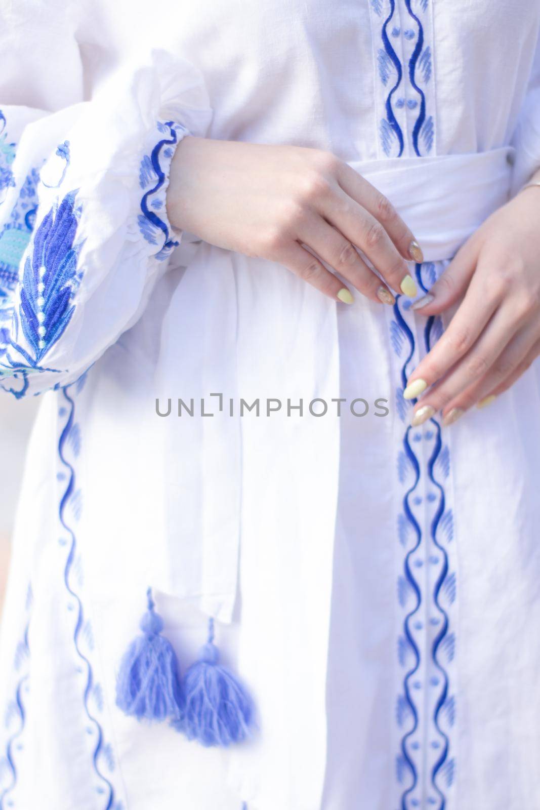 close up of national traditional ukrainian clothes. details of woman in embroidered dress. unrecognizable person.