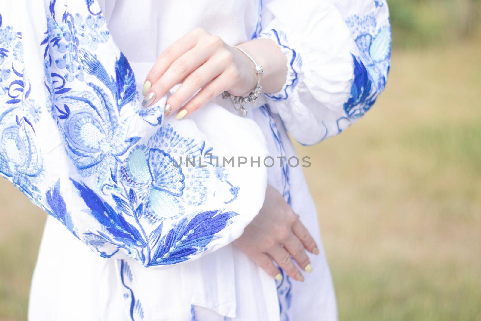 close up of national traditional ukrainian clothes. details of woman in embroidered dress. unrecognizable person.