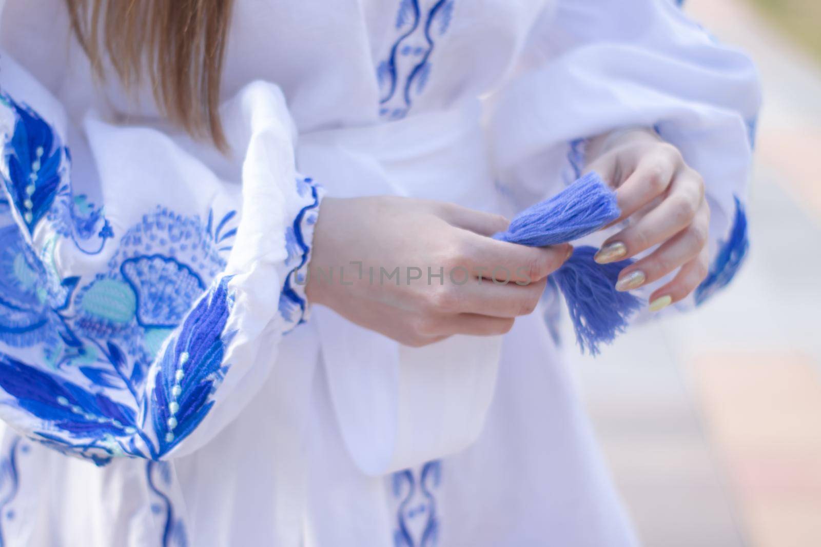 close up of national traditional ukrainian clothes. details of woman in embroidered dress. unrecognizable person by oliavesna