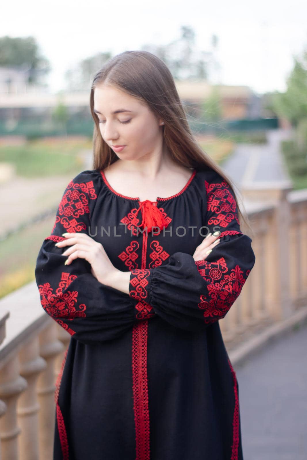 portrait of young woman wearing black and red vyshyvanka. national embroidered Ukrainian shirt. girl in dress outdoors in park. summer by oliavesna