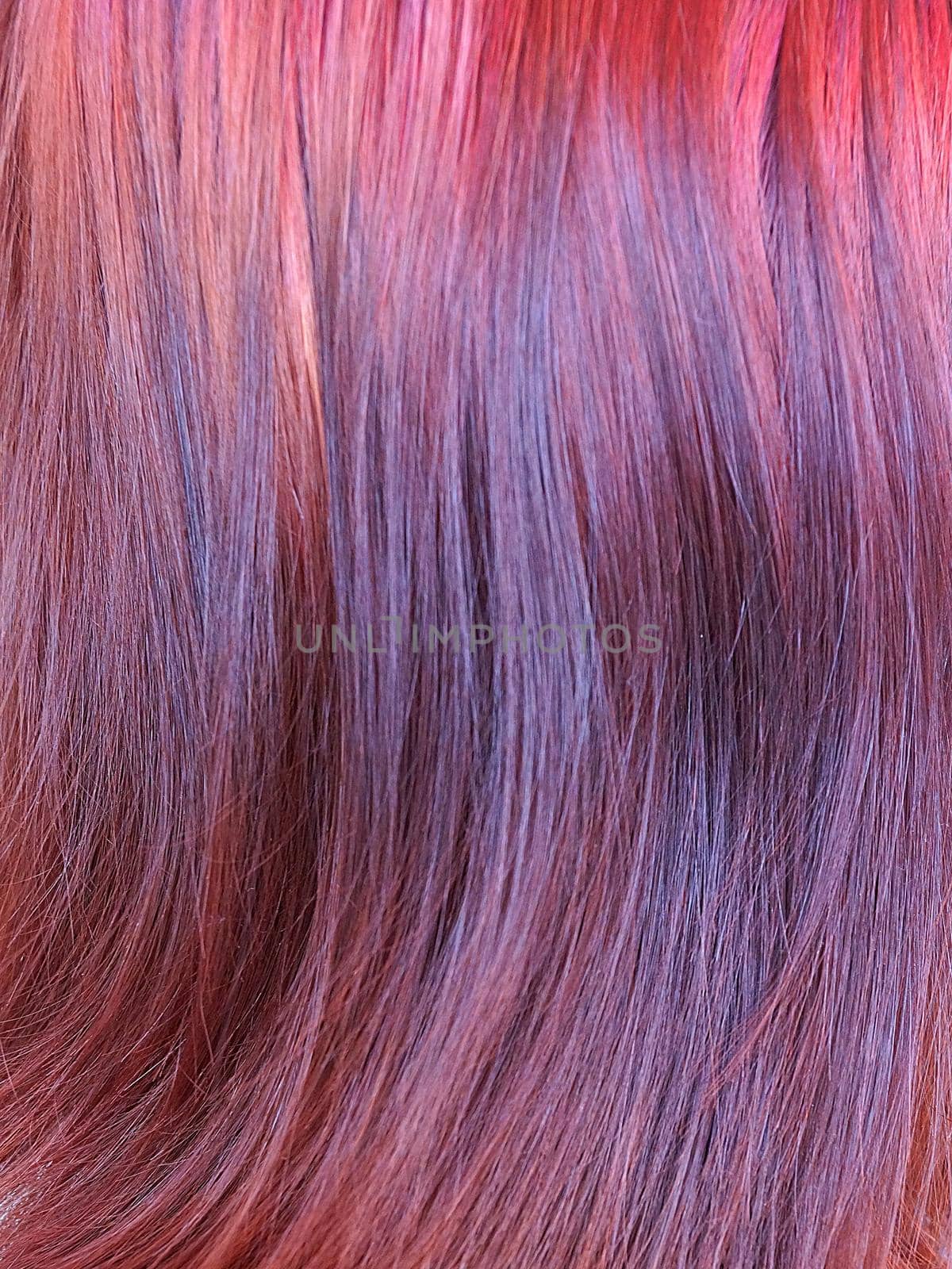 dyed red female hair closeup, texture for background.