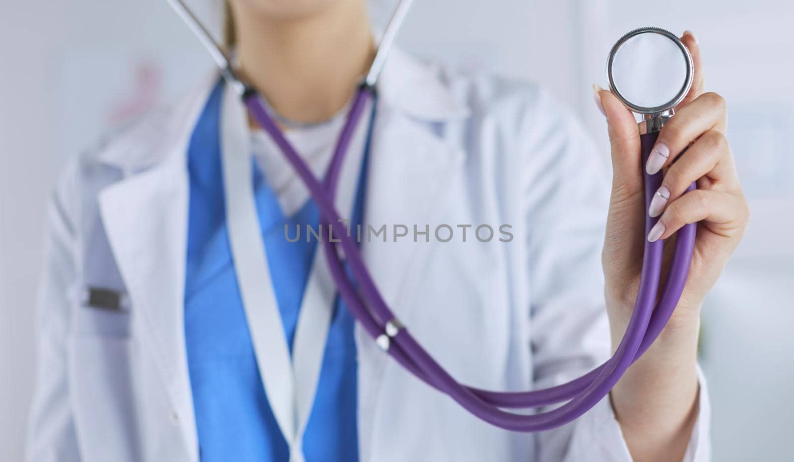 Smiling medical doctor woman with stethoscope in hospital.