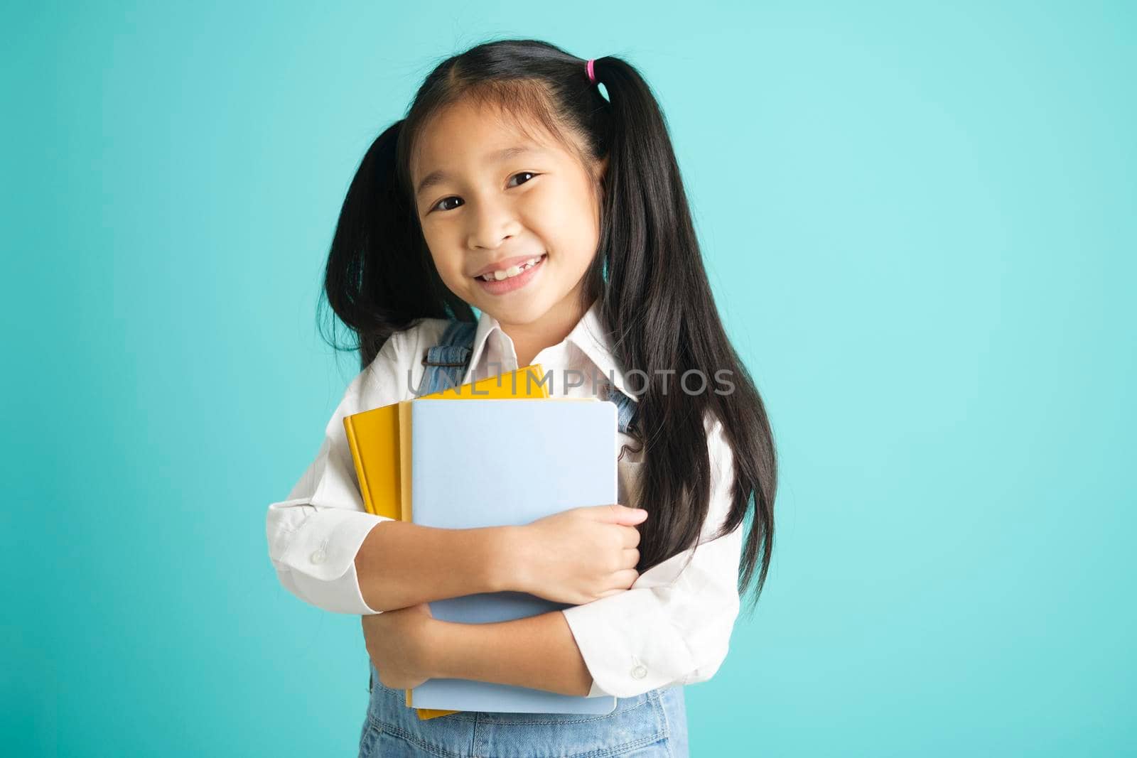 Close-up kid students girl smiling holding book, going to school. by ijeab