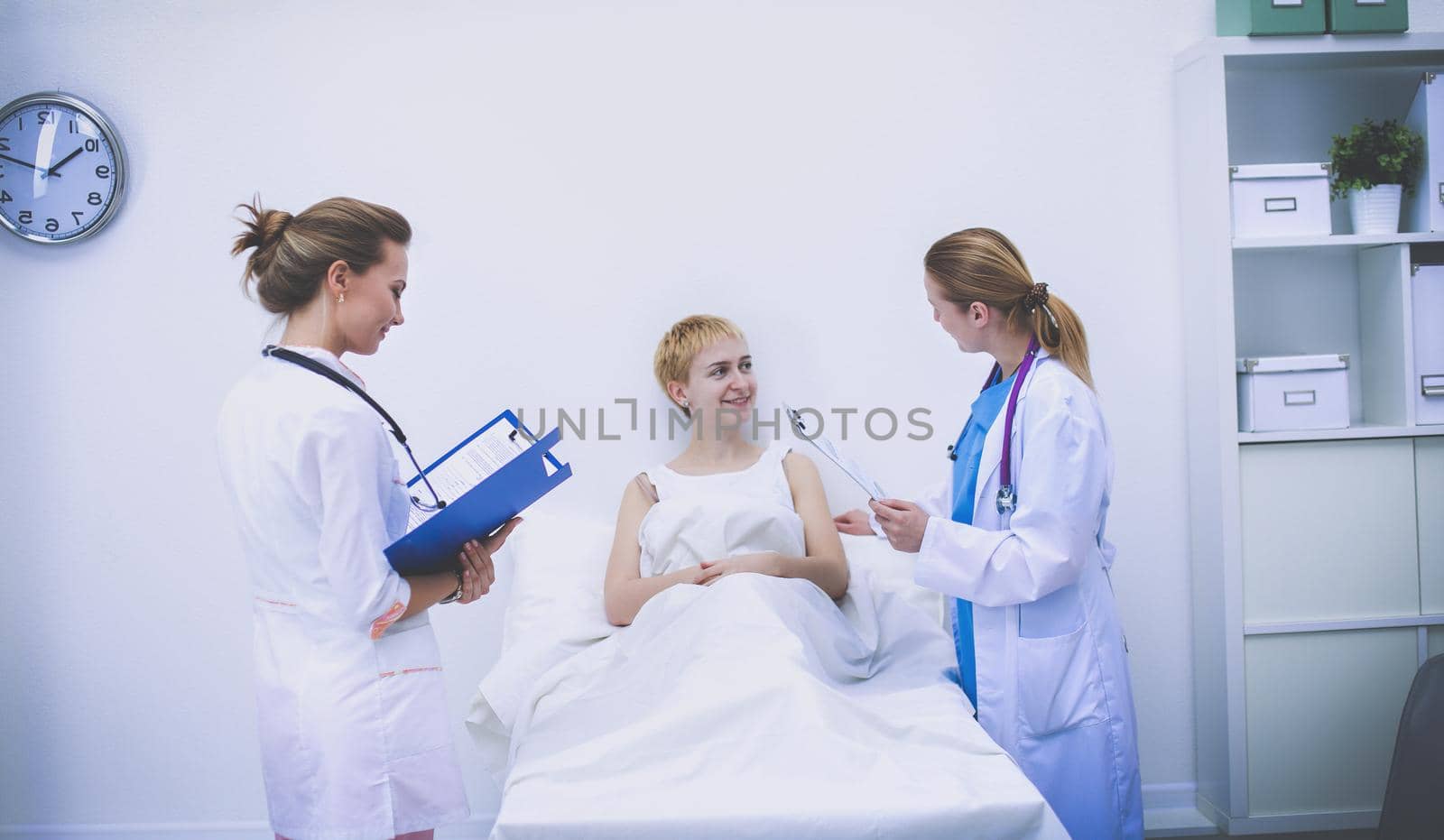 Young woman doctor standing at hospital with medical stethoscope.
