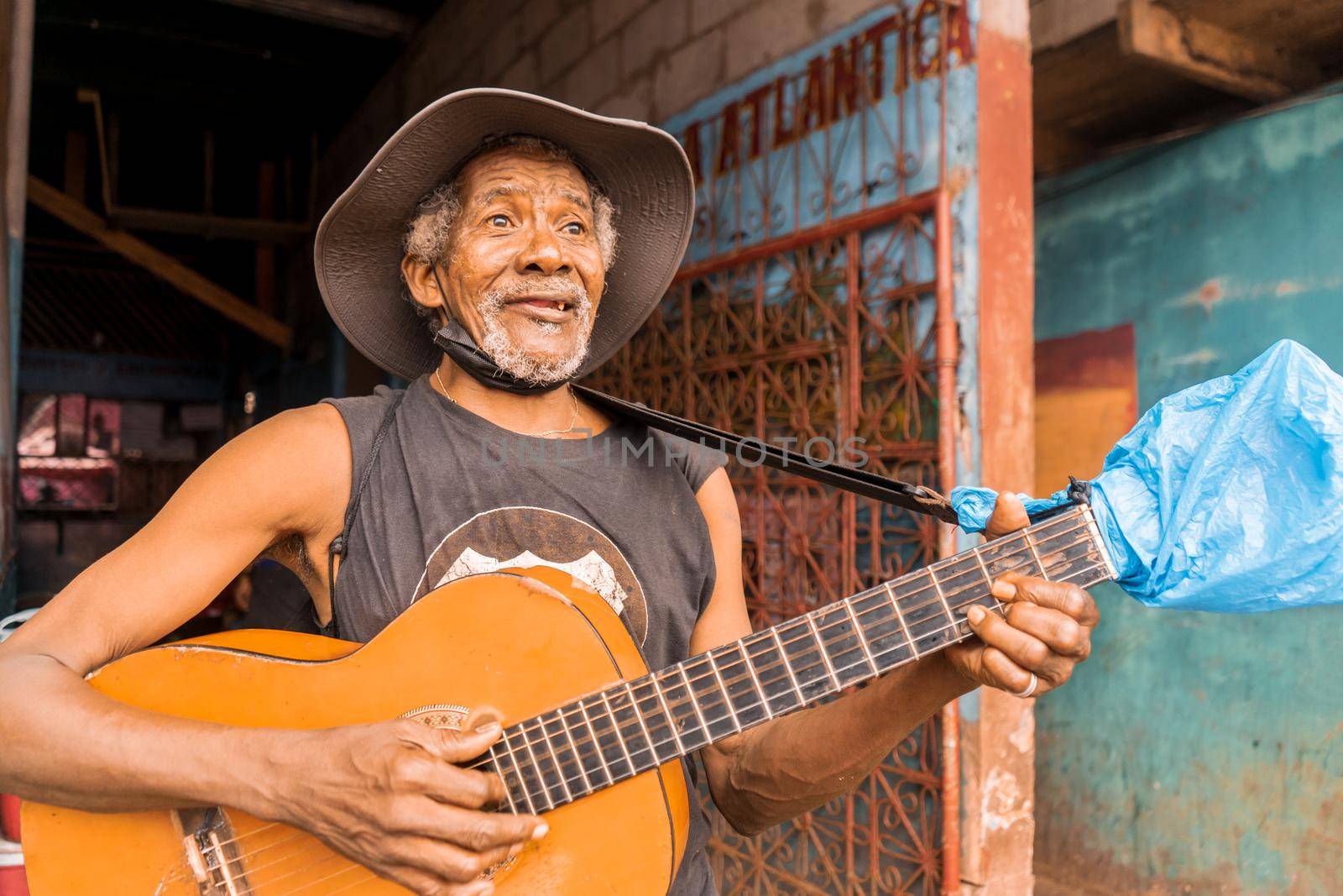 Native African American singer from Bluefields Nicaragua smiling and playing guitar and singing