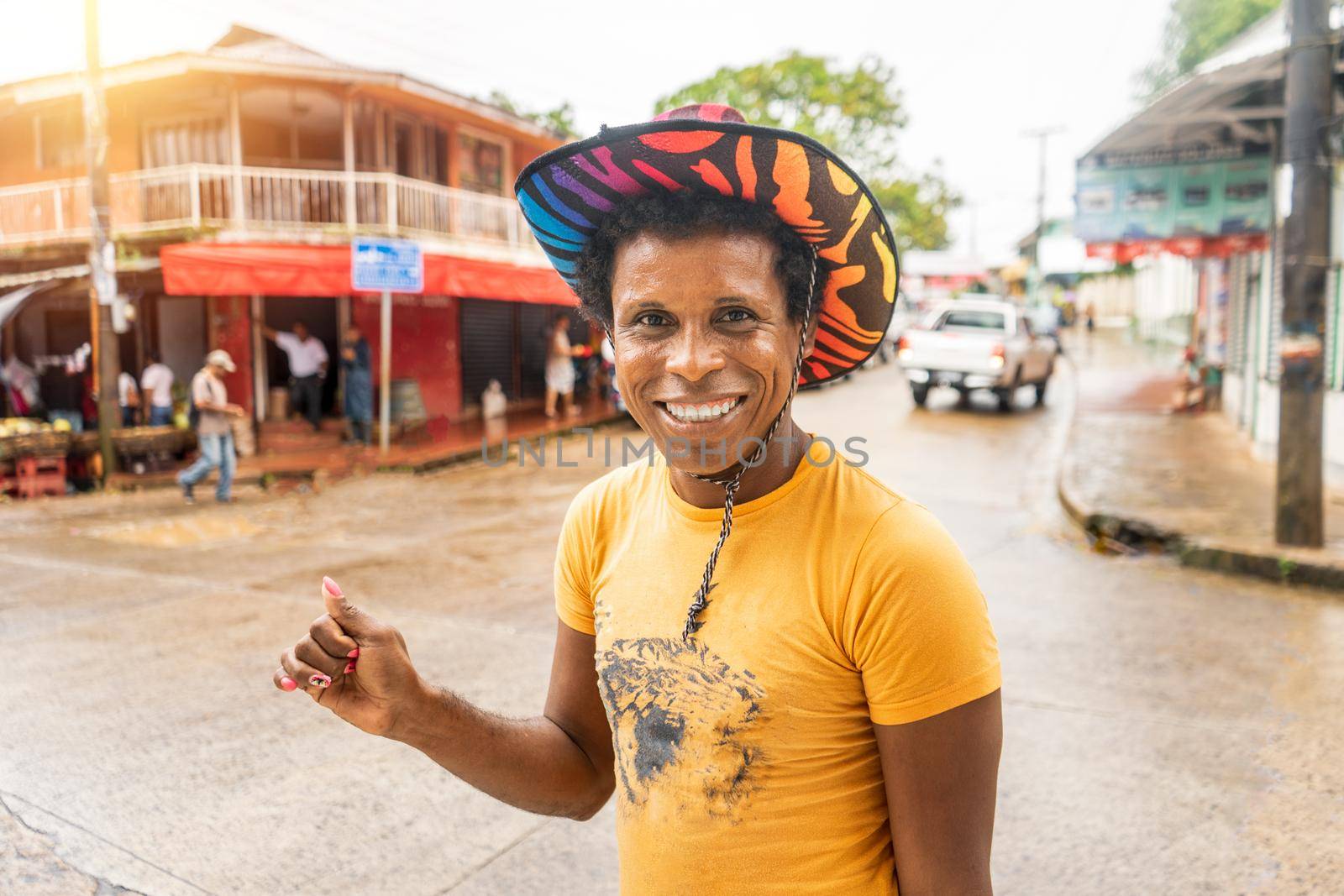 Black skinned latino gay with colorful hat smiling and looking at camera in Bluefields Nicaragua