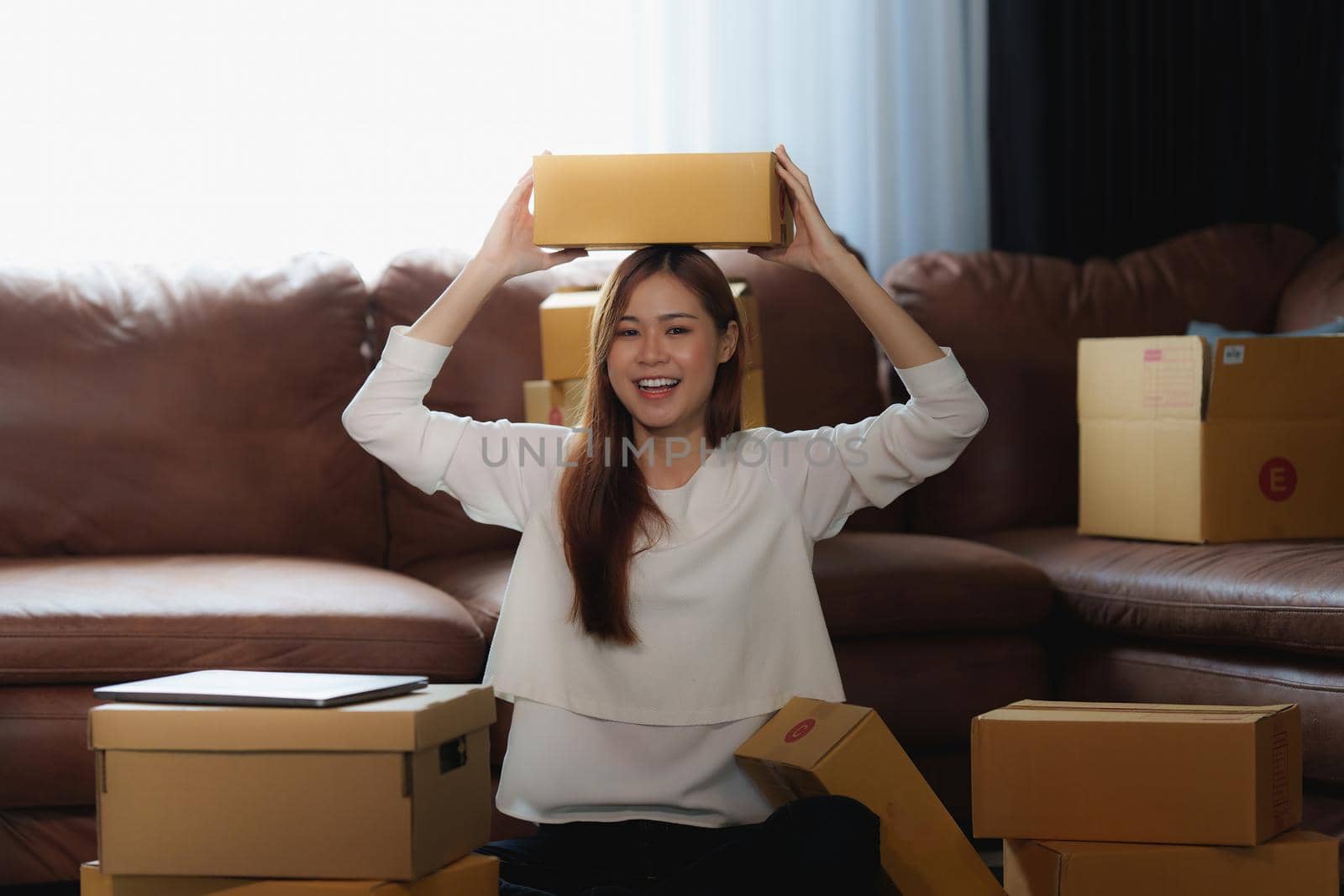 Image of Young asian woman startup freelance with parcel box. Online marketing packing box delivery concept. by itchaznong