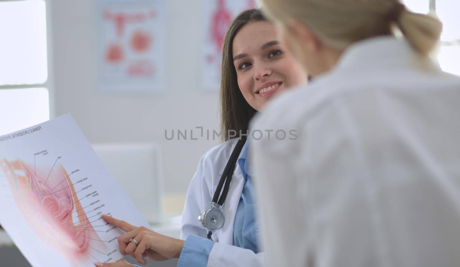 Doctor and patient discussing something while sitting at the table . Medicine and health care concept.