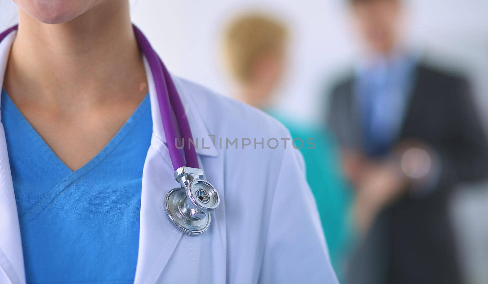 Woman doctor standing with stethoscope at hospital .