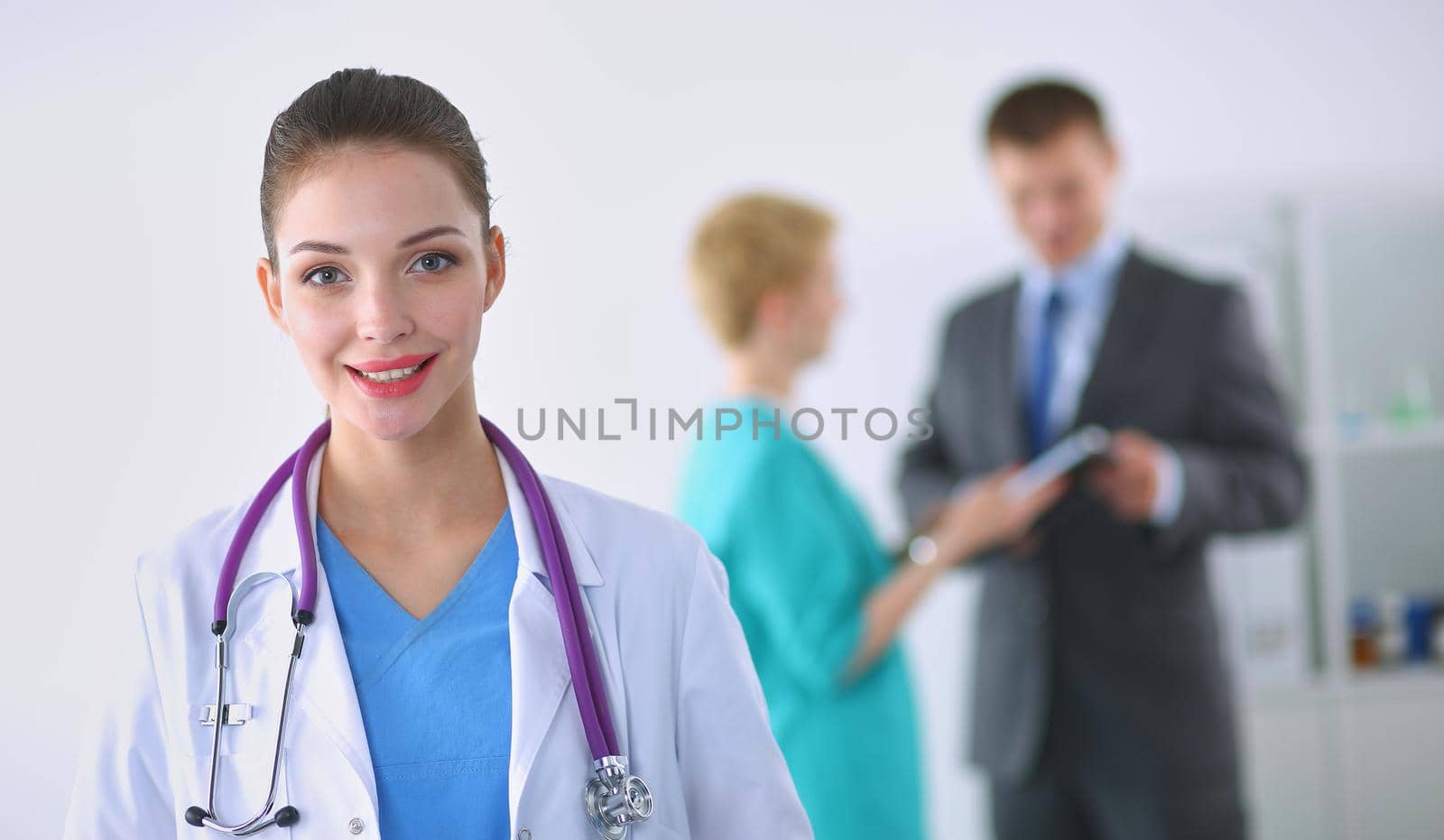 Woman doctor standing with stethoscope at hospital .