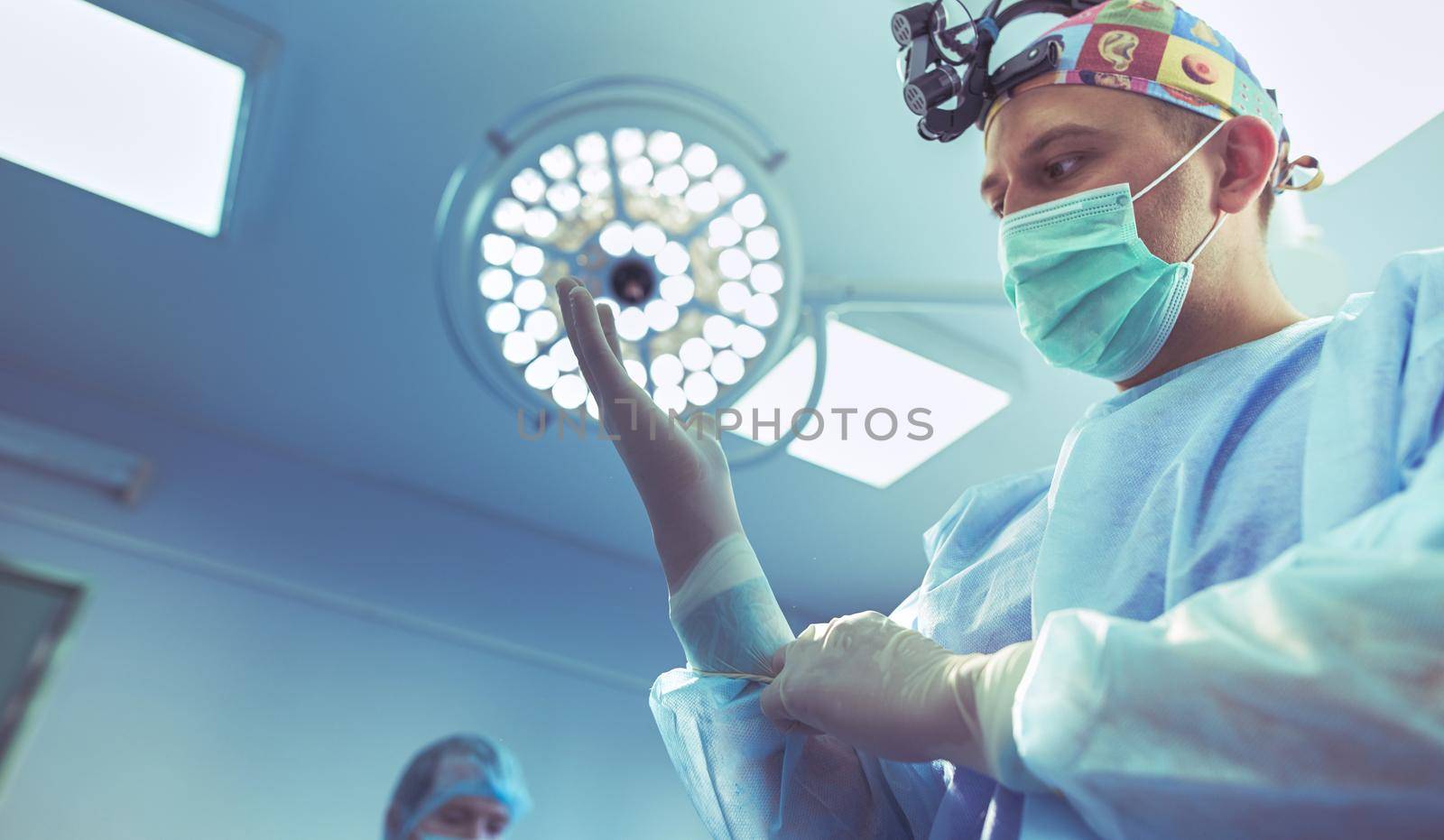 Man surgeon at work in operating room.