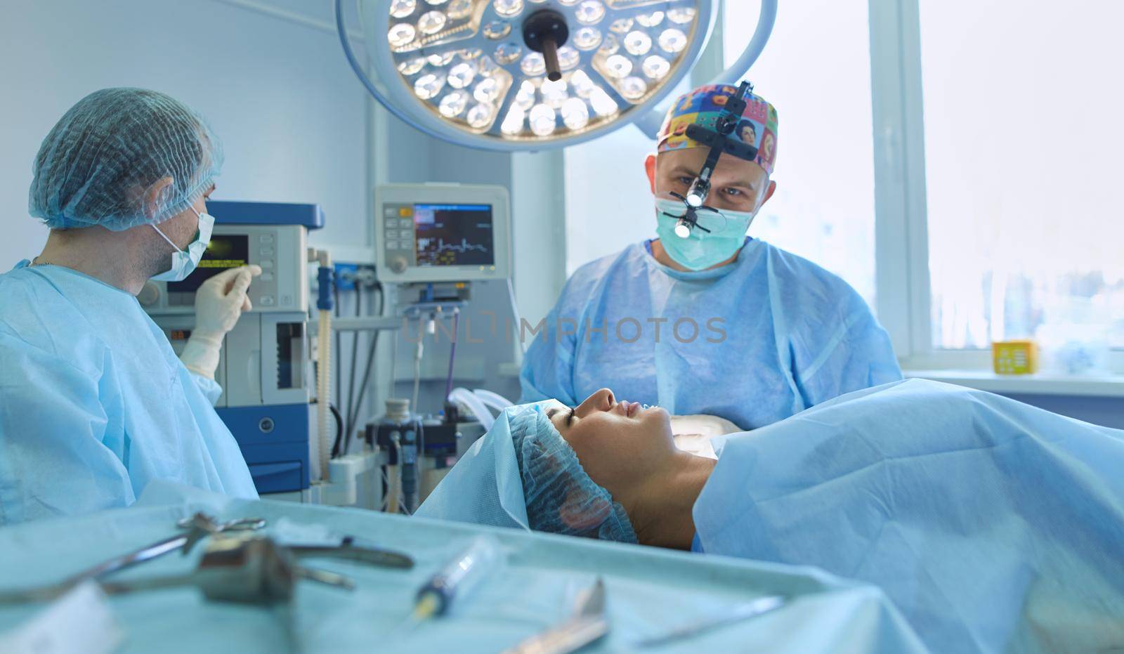 Man surgeon at work in operating room.