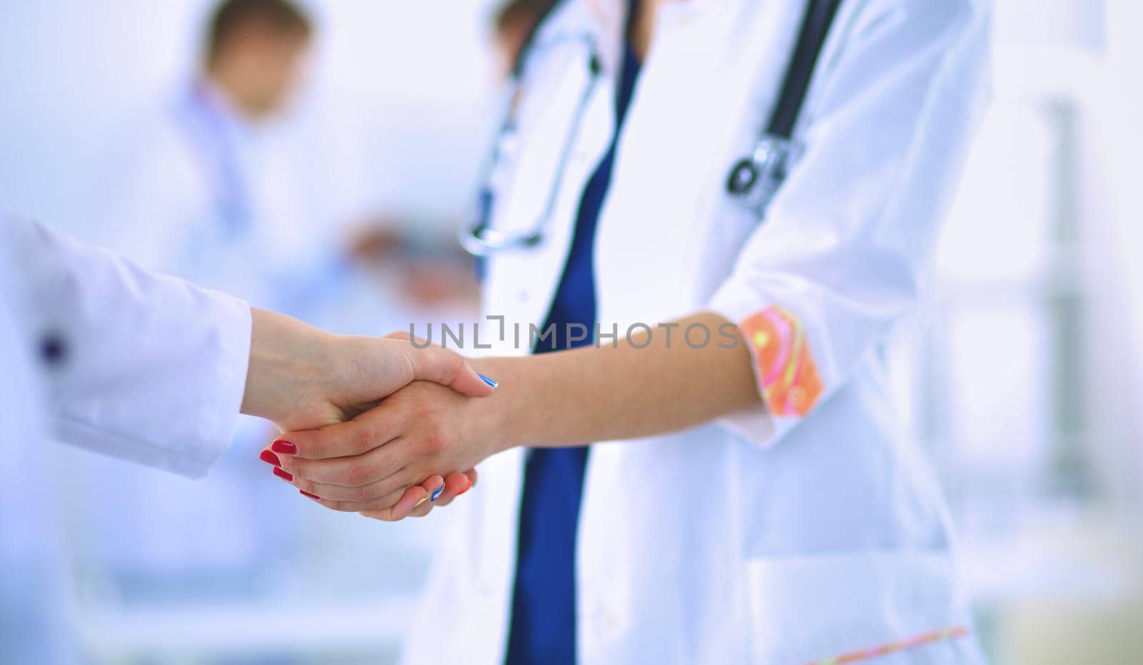 Young medical people handshaking at office .