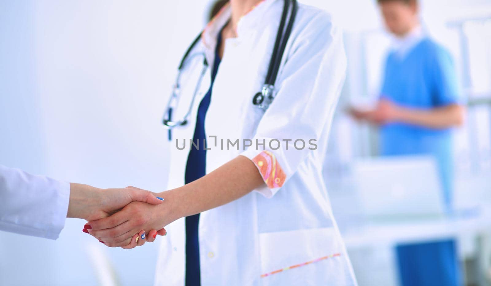Young medical people handshaking at office .