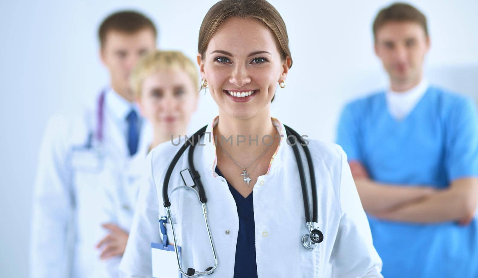 Attractive female doctor in front of medical group by lenets